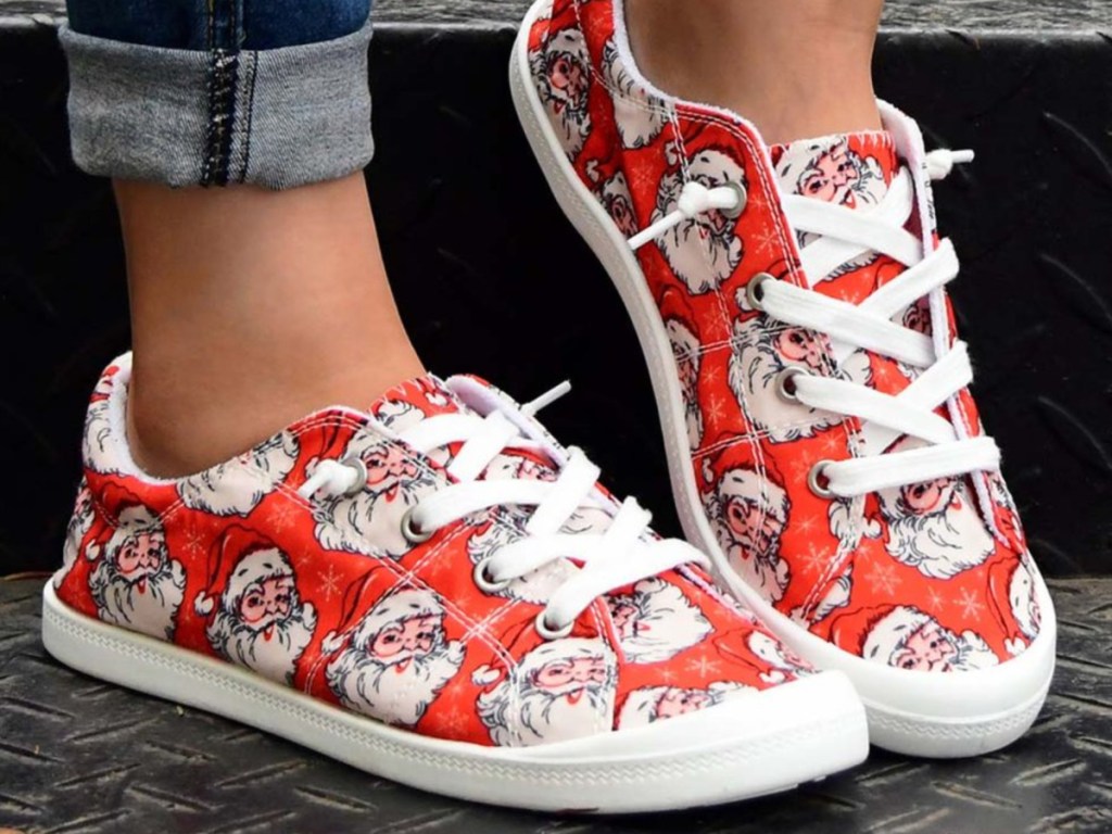 woman wearing red santa sneakers