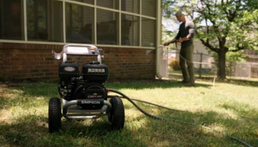 man using a Simpson Pressure Washer
