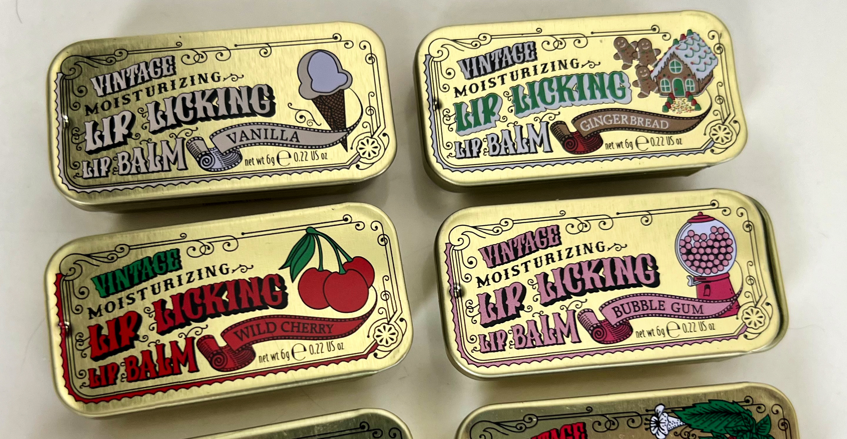 Four Tinte Cosmetics Vintage Lip Licking Lip Balm tins