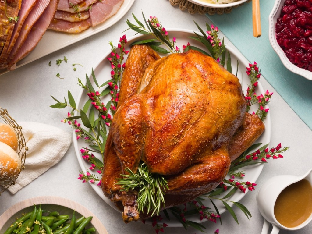 turkey plated with rosemary and side dishes