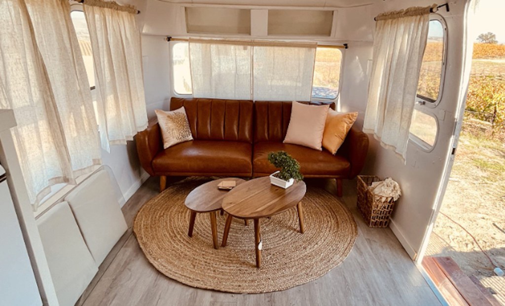 brown faux leather couch in airstream trailer