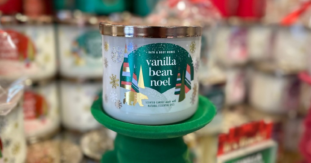 bath & body works candle on a green velvet pillar