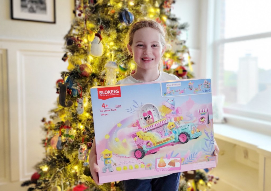girl holding blokees set near christmas tree