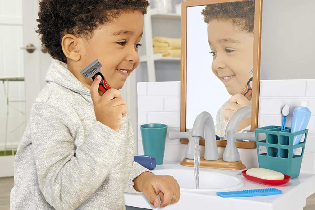 child playing with kids sink