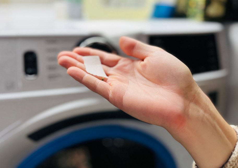 hand holding a piece of natural laundry detergent sheet