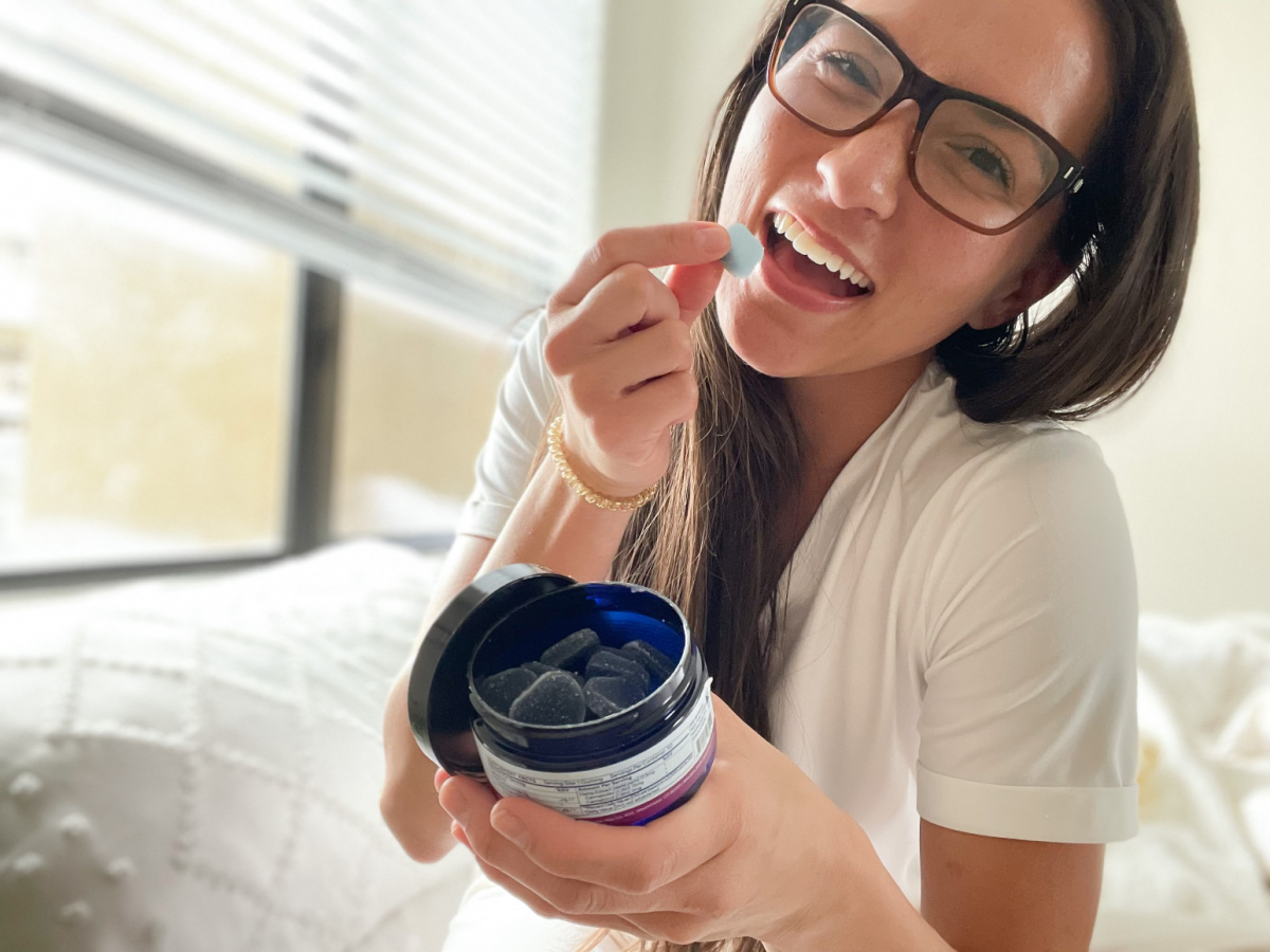 woman eating a sleep gummy