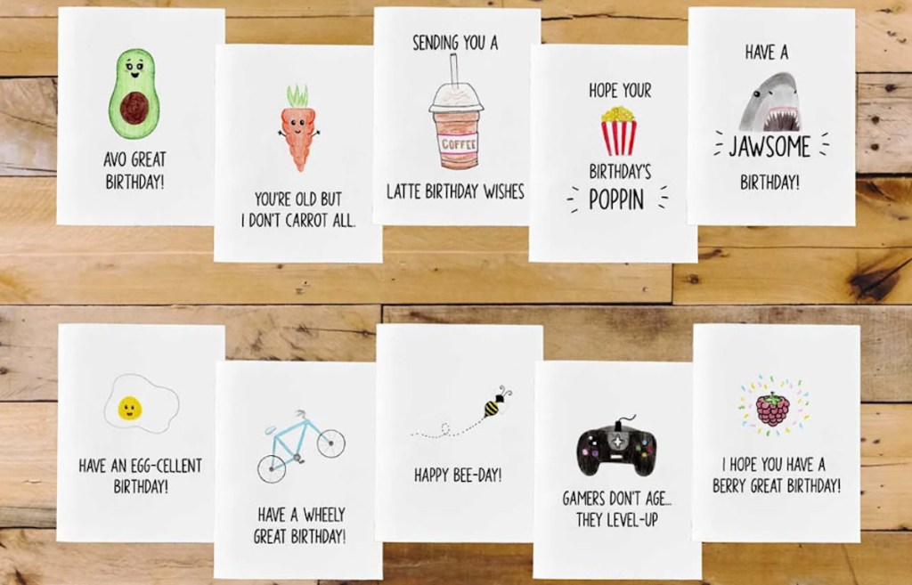 various punny birthday cards on wood table