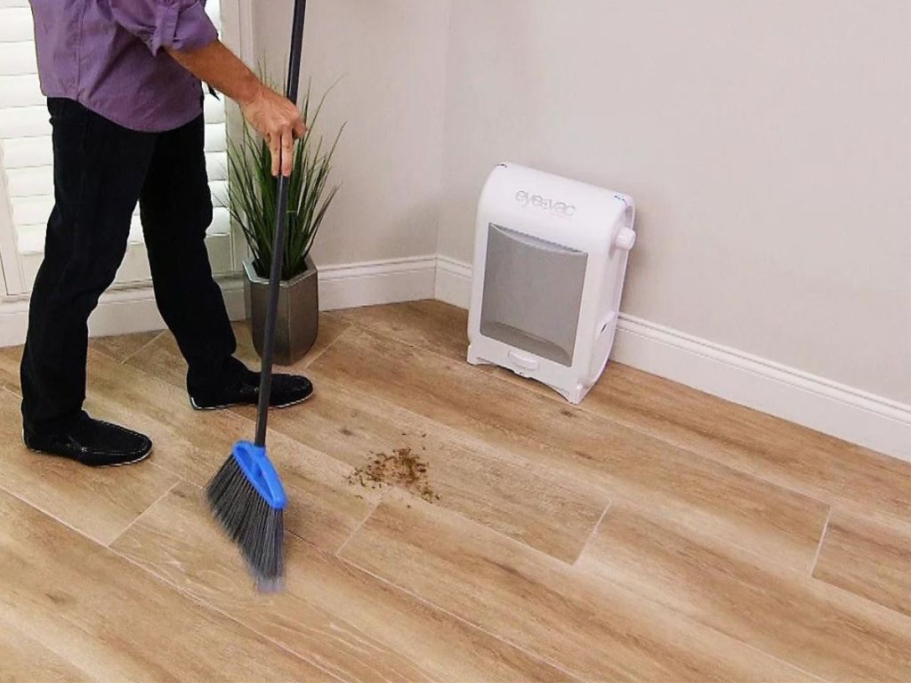 man sweeping crumbs into eyevac