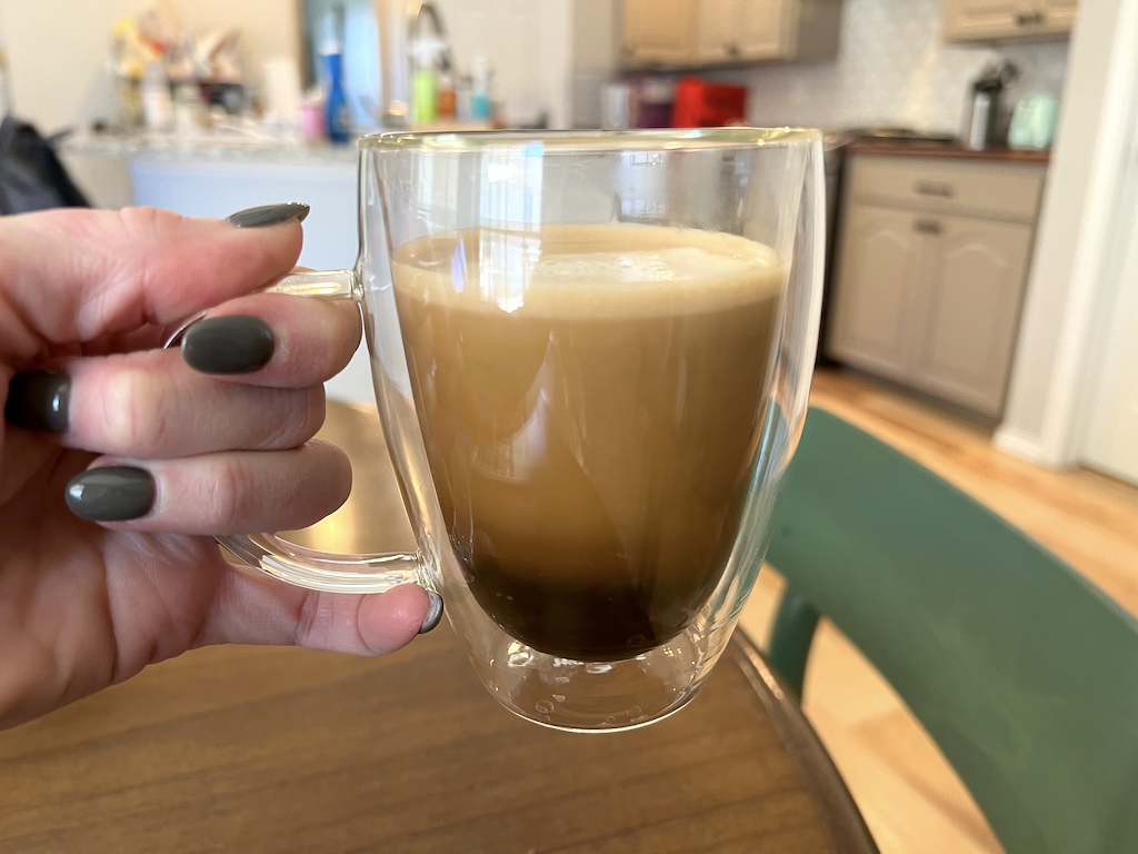 holding glass coffee mug 