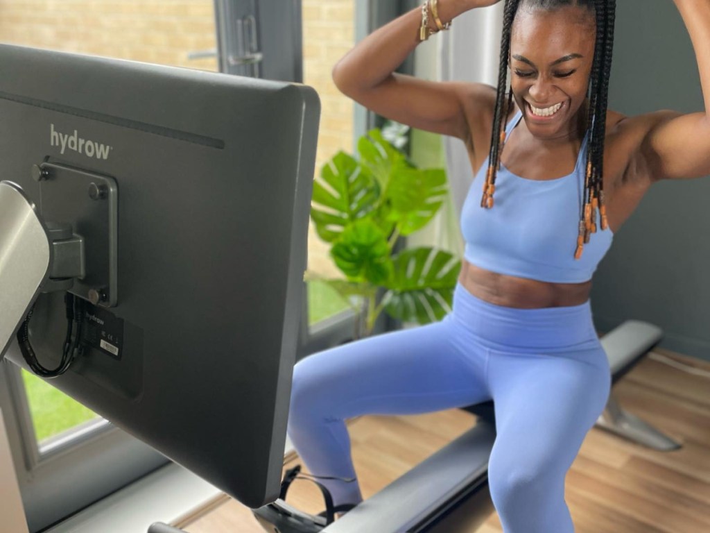 woman excited on hydrow machine