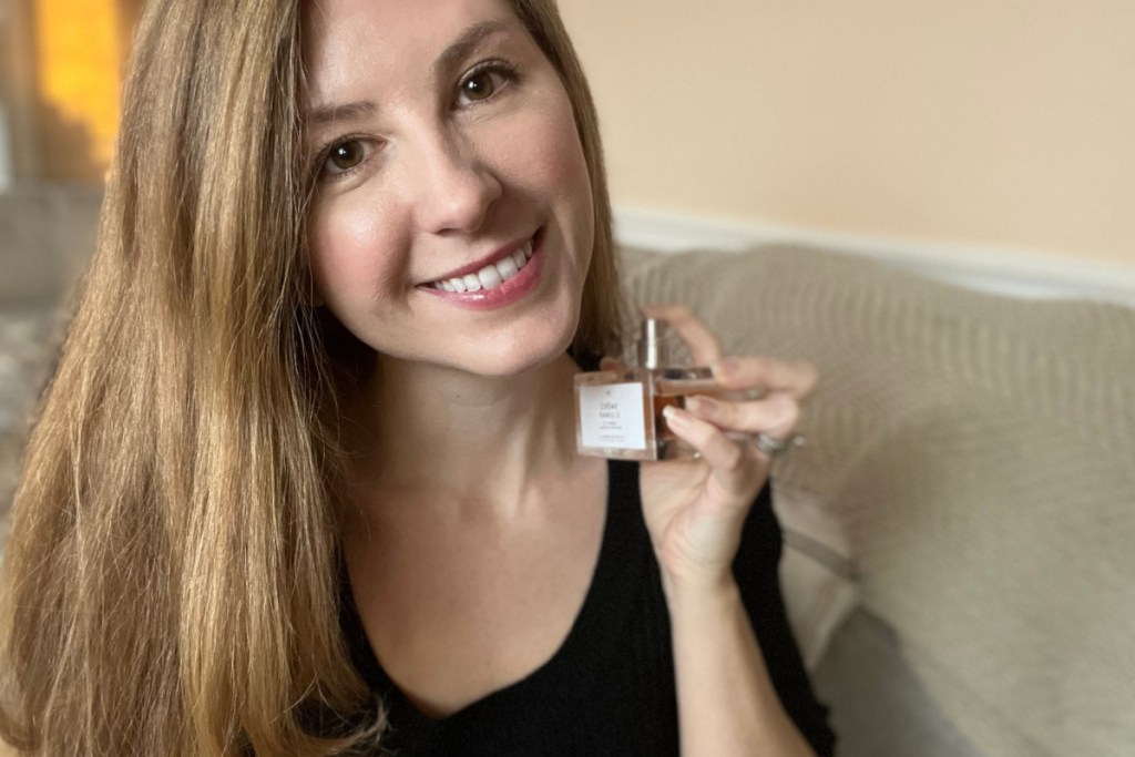 woman holding perfume