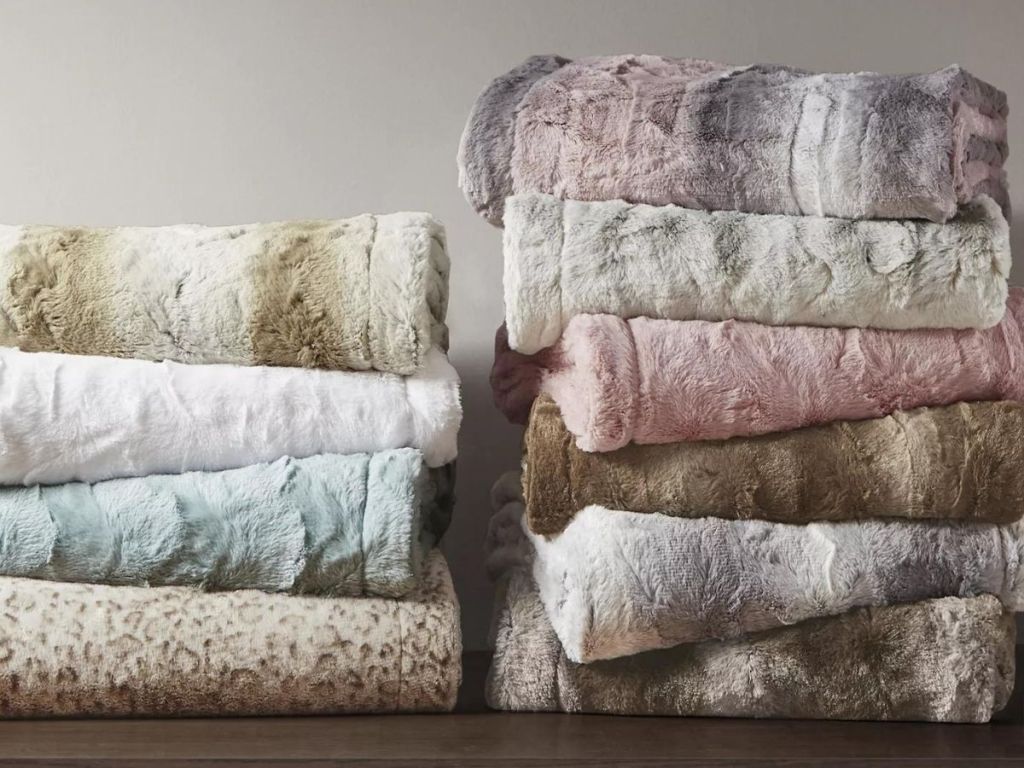 2 stacks of faux fur throws