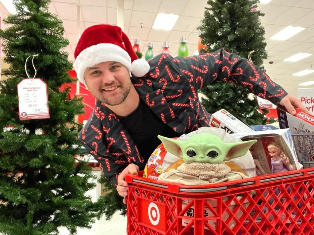 man holding onto target cart full of gifts