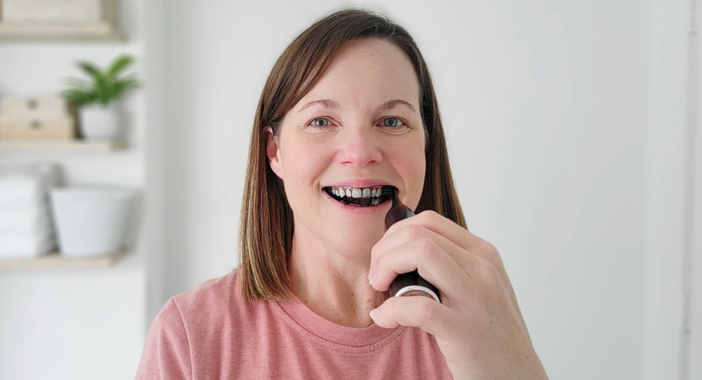 woman brushing with chacoal powder