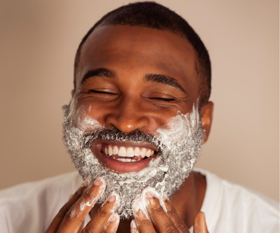 man rubbing shaving cream on beard