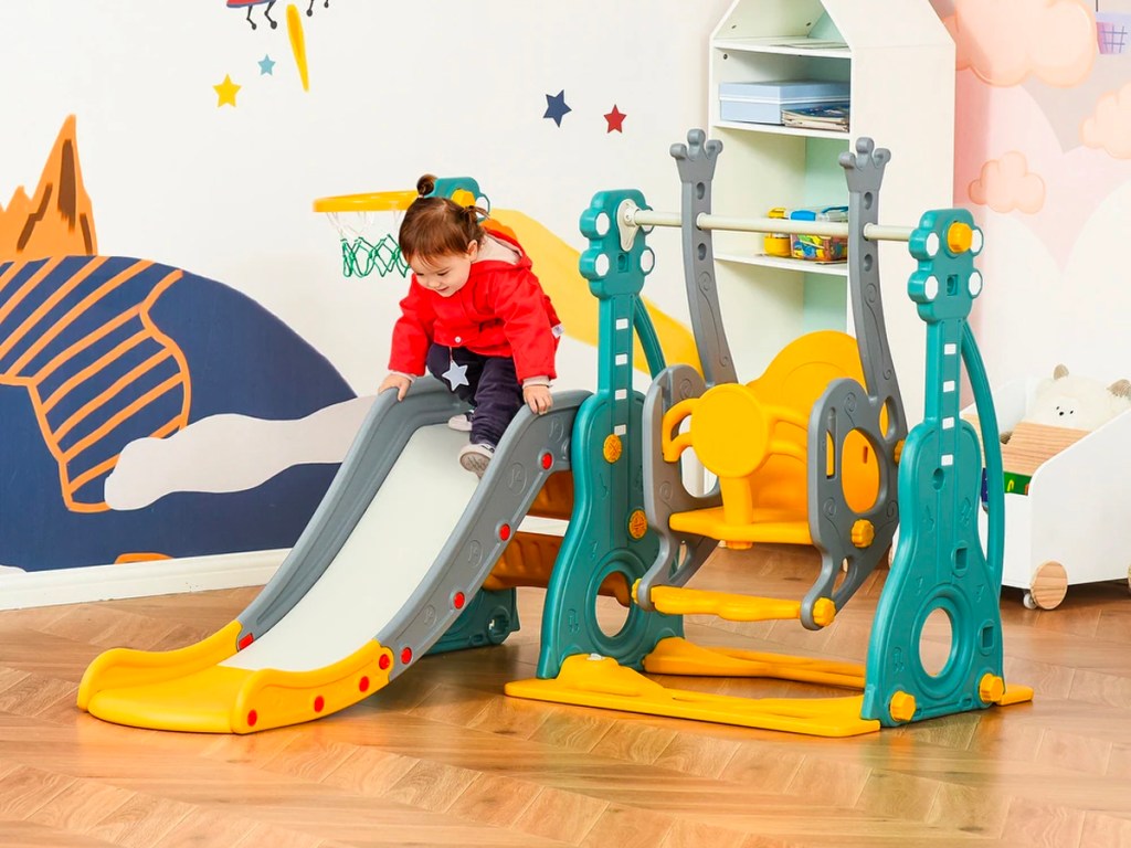 toddler playing on playset in room