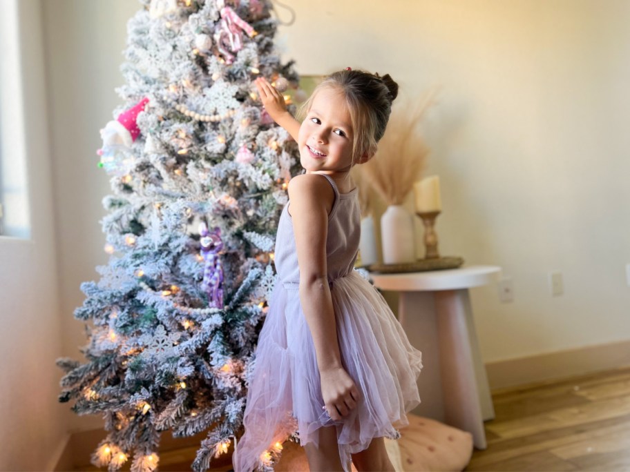 girl standing in front of tree