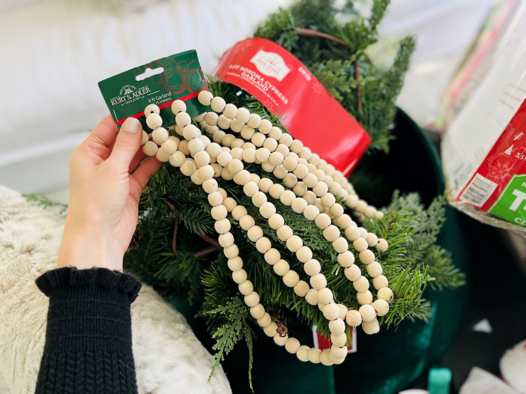 hand holding walmart christmas decorations garland