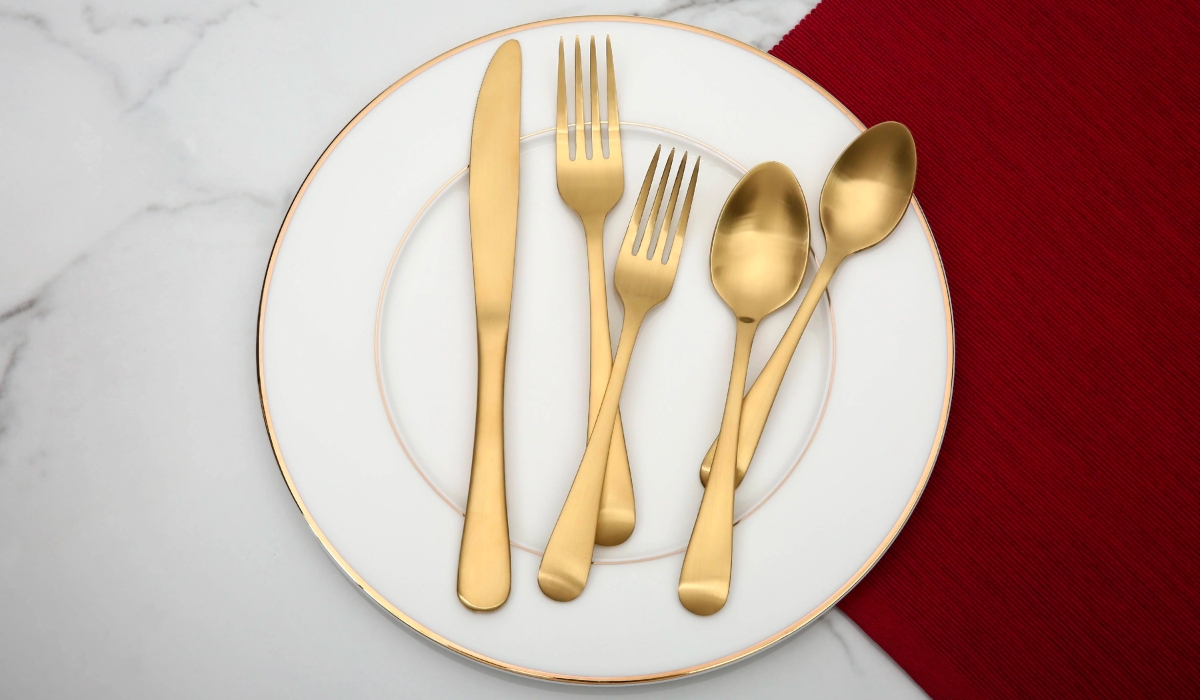 better homes & gardens matte gold flatware set on dining plate