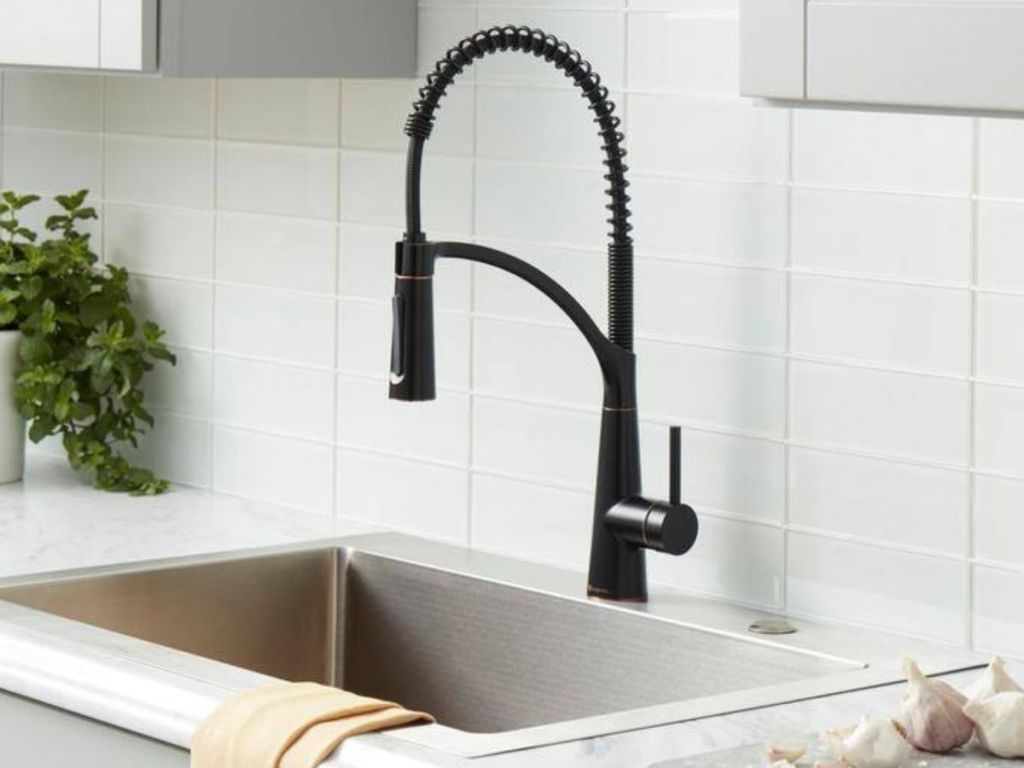 a bronze pull-down faucet in a kitchen