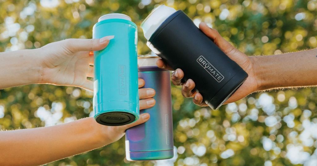 3 people cheersing holding teal, black, and rainbow Brumasters