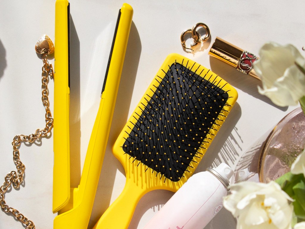 yellow flat iron next to matching yellow hair brush