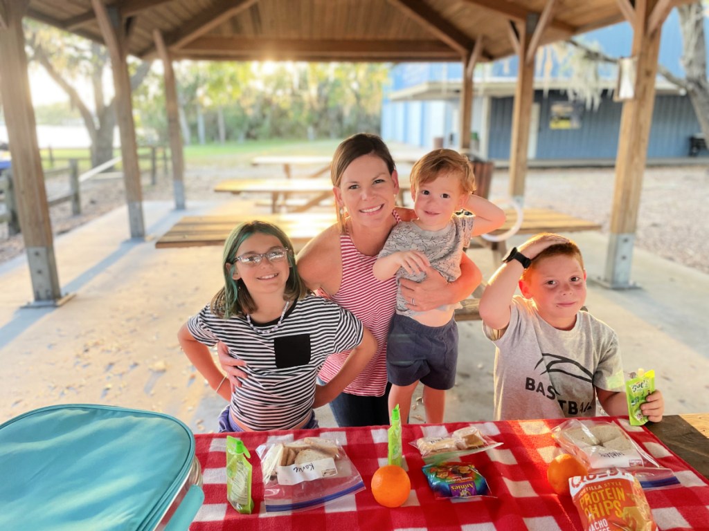 A family enjoying an outdoor picnic on a camping trip