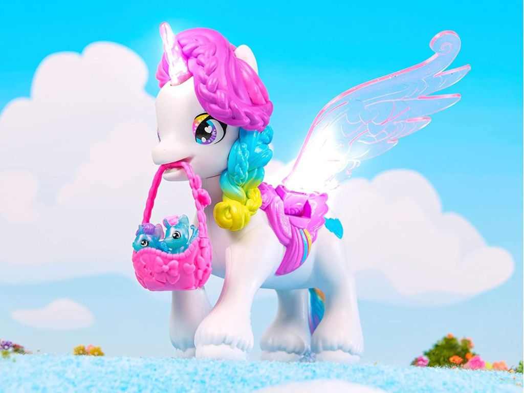 Toy unicorn holding a basket with babies in it