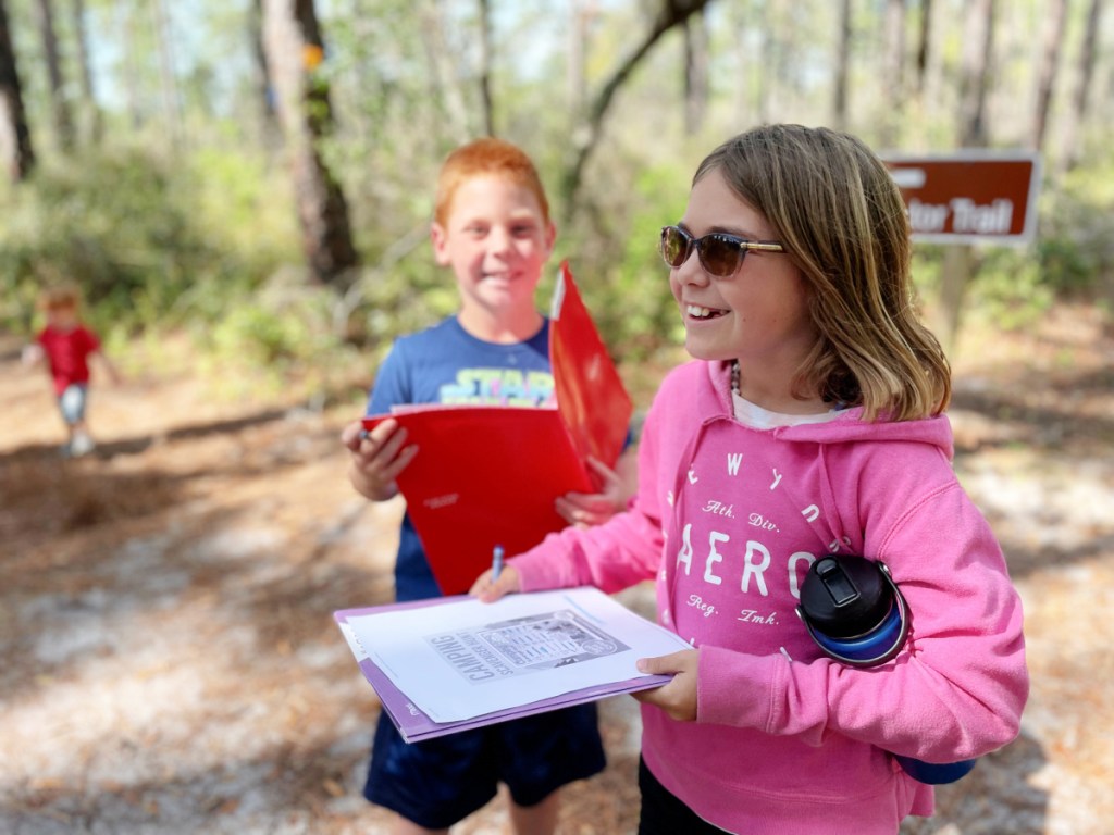 Kids doing a scavenger hunt while camping