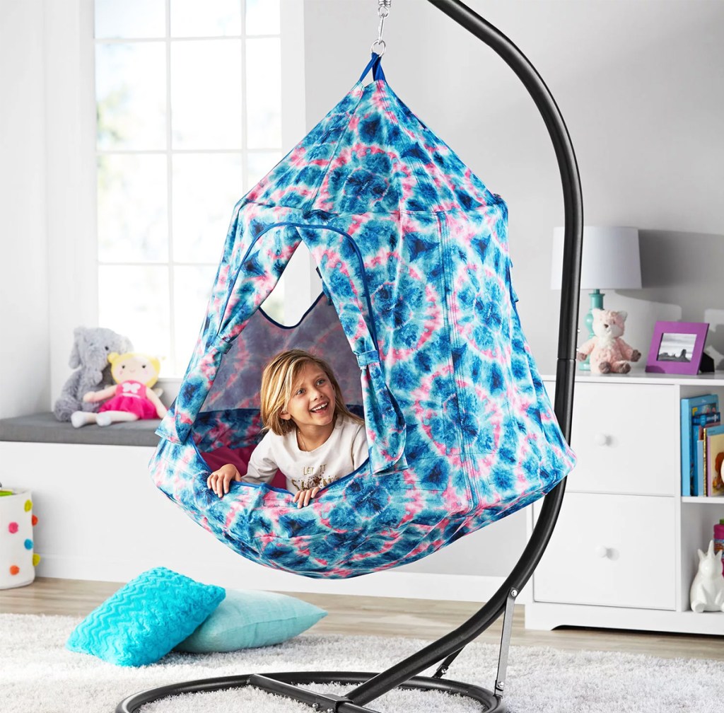 kid in tie dye hanging tent pod