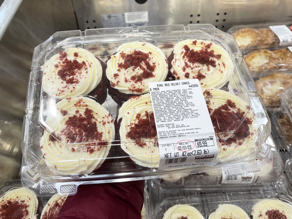 hand holding 6-pack of Mini Red Velvet Cakes