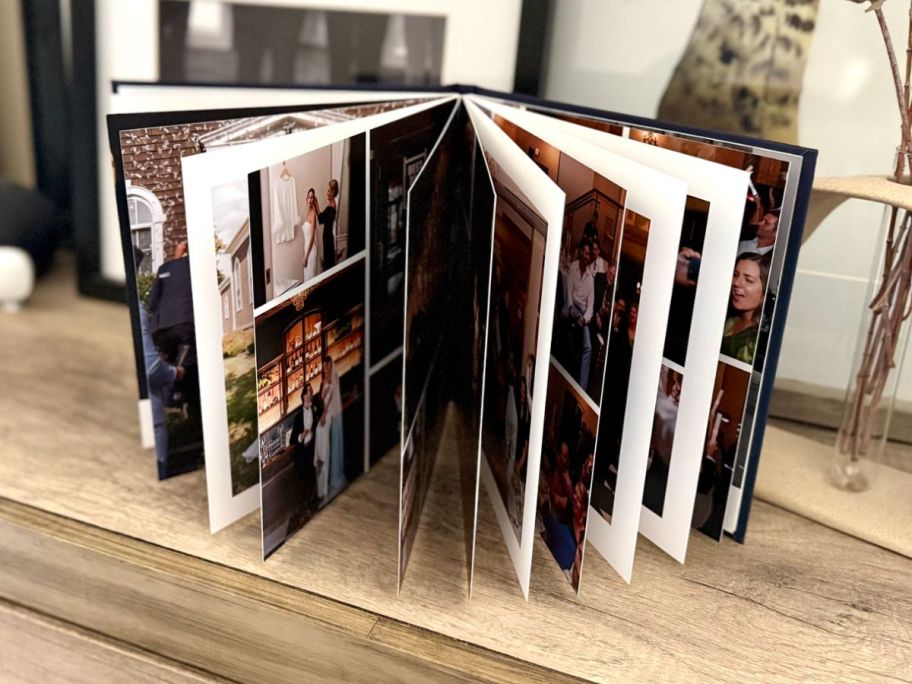 Mixbook with photos opened up on top of the table 