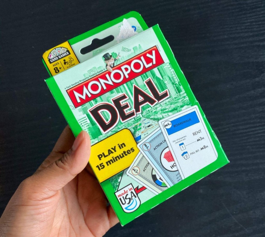 Hand holding a Monopoly Card Game