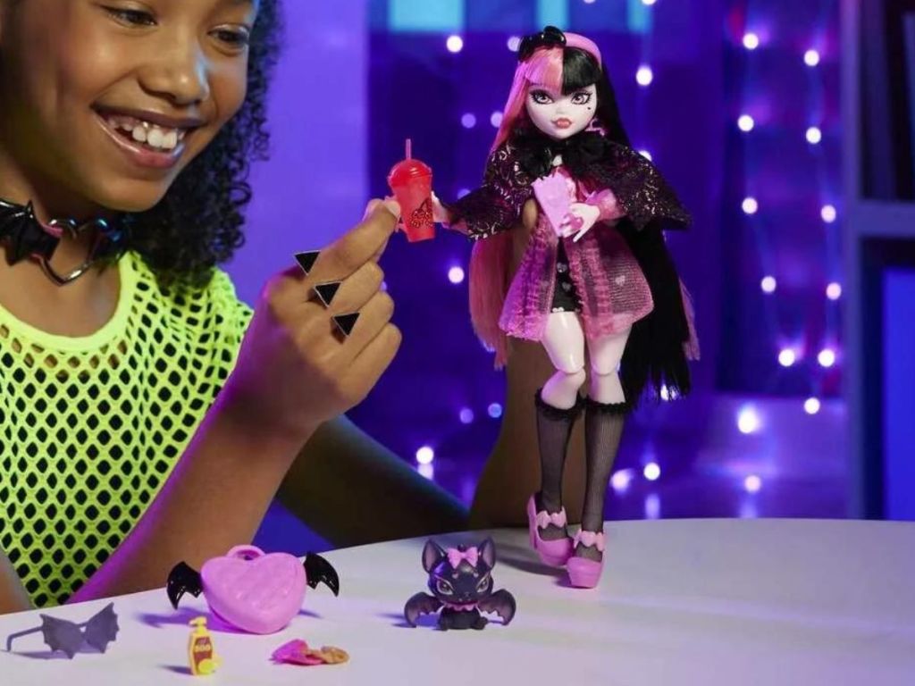 Girl playing with a Monster High Draculaura Doll