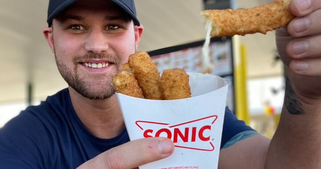 A guy holding an order of Sonic Mozzerella sticks