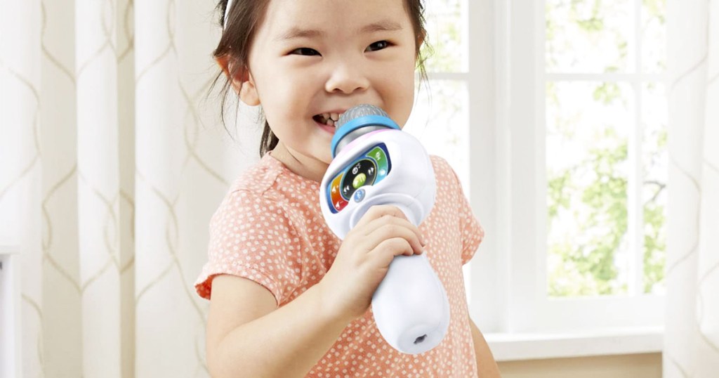 girl holding vtech microphone