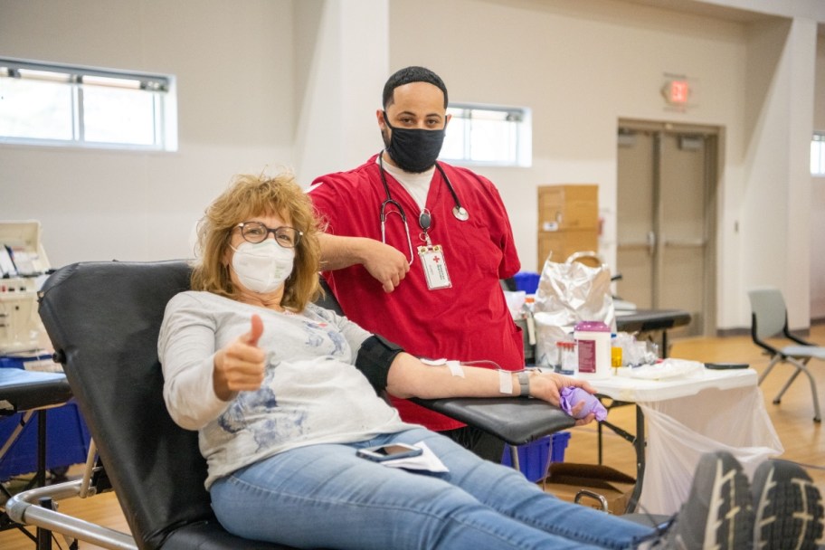 woman donating blood, one way how to help after tragedy