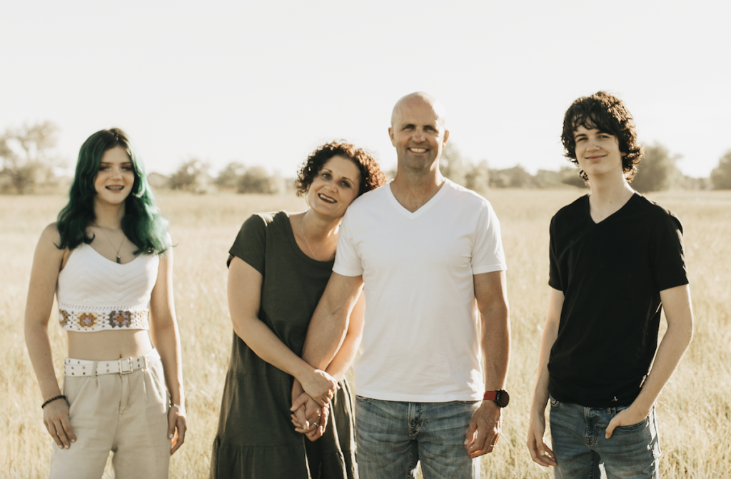 family standing outside in field 