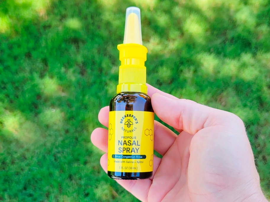 beekeepers nasal spray in hand