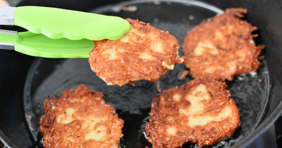 cast iron pan with finished potato latkes, a Jewish recipe for Hanukkah