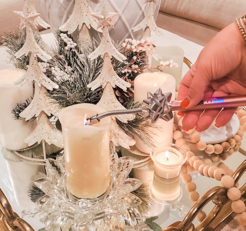 hand holding an electric lighter over candle last minute christmas gifts