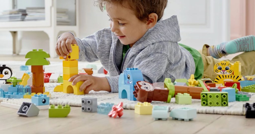 boy playing with LEGO duplos