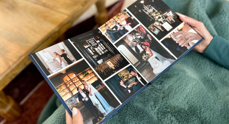 hand holding mixbook opened up to a collage page while sitting down