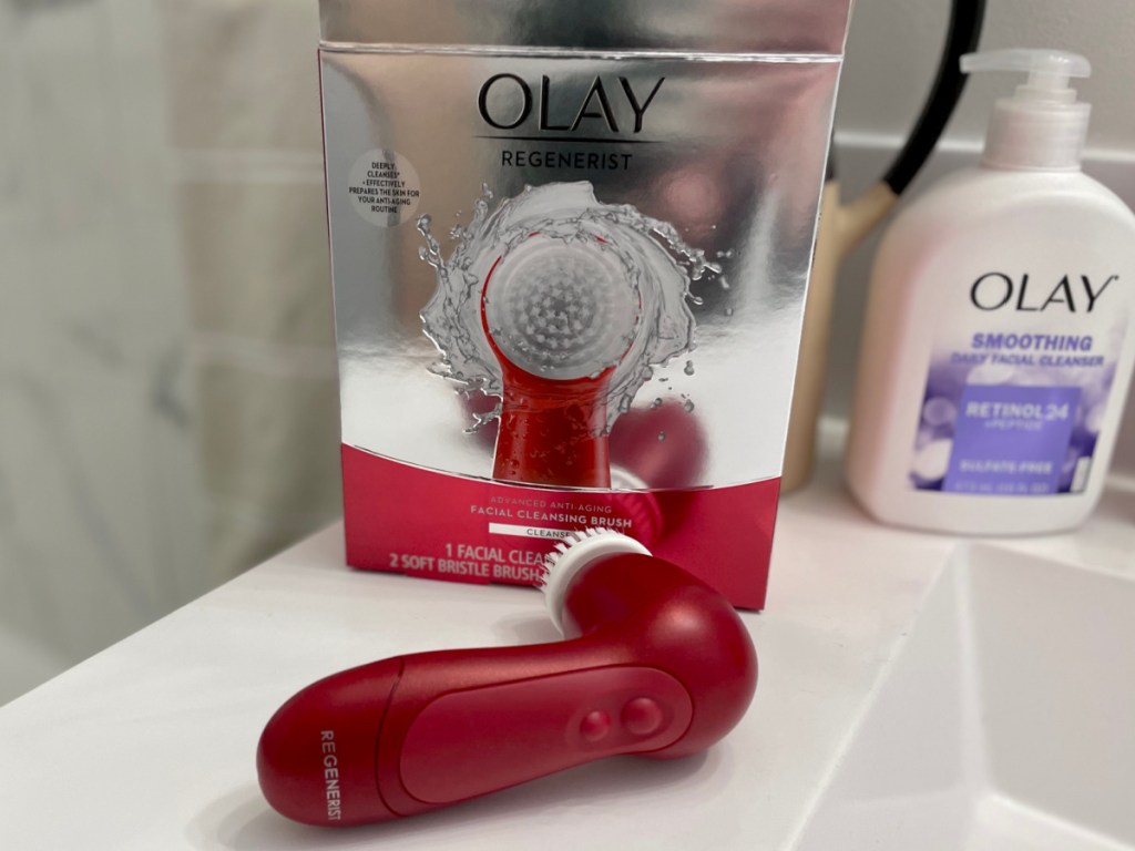 olay facial brush box and cleanser near sink