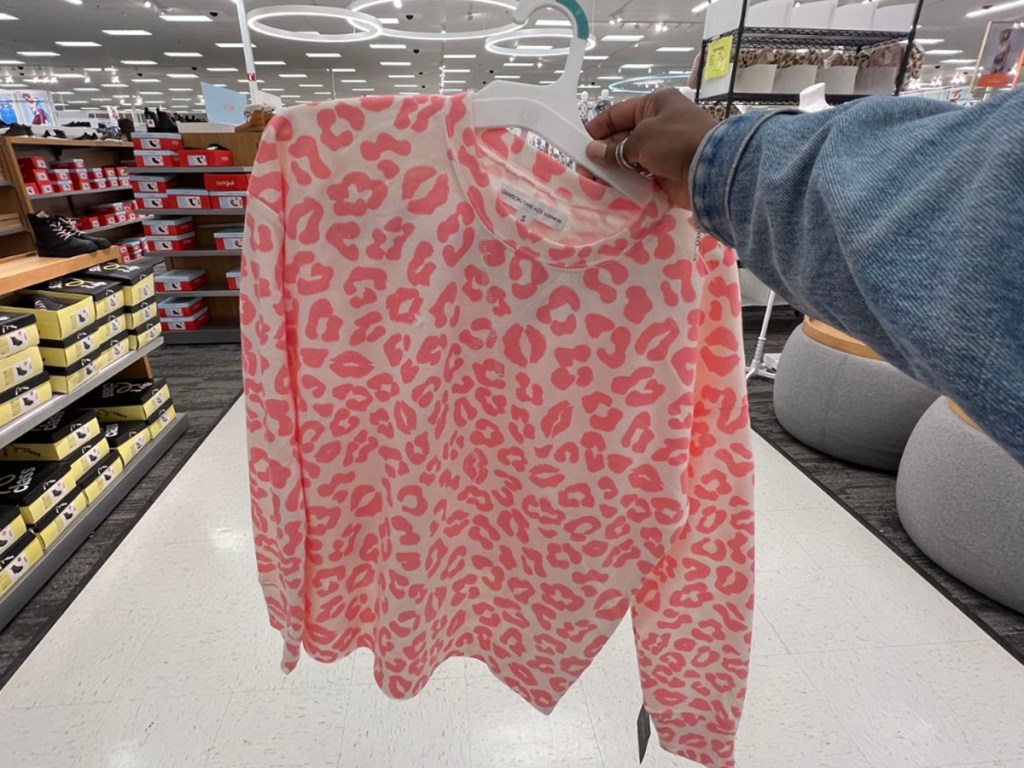 woman holding valentines pajamas in target