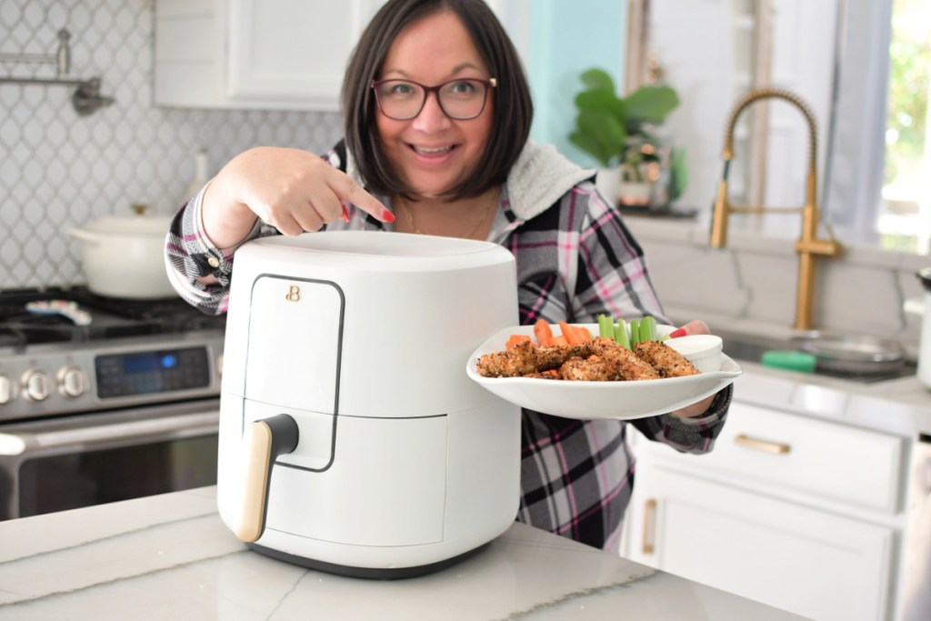 woman using air fryer to make chicken tenders