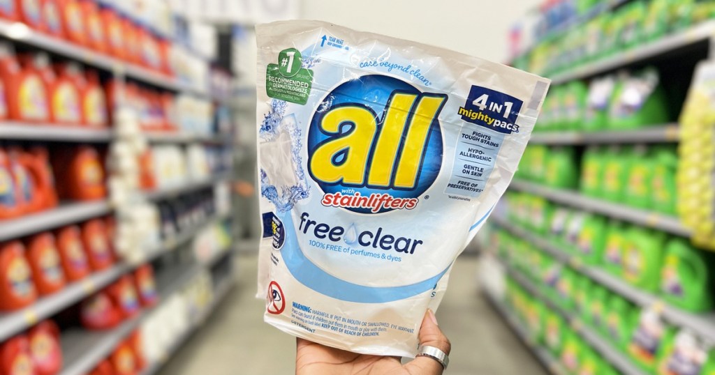 hand holding up a pack of all free clear laundry detergent pacs