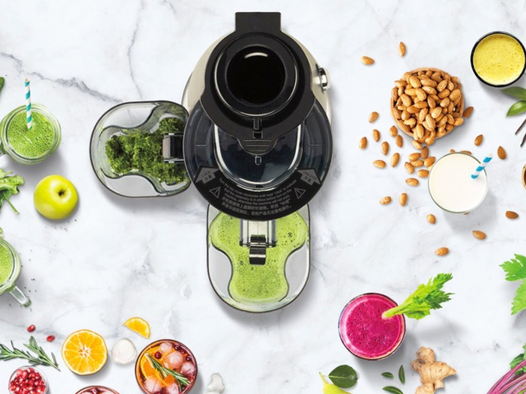 juicer on kitchen counter making green juice