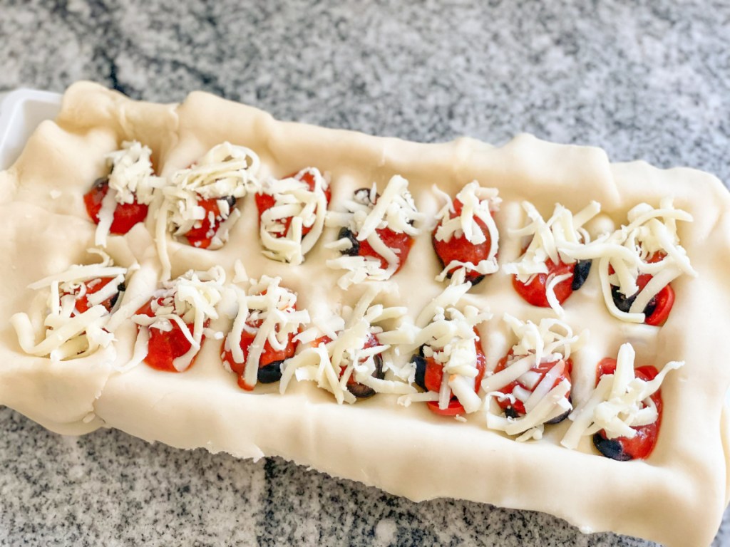 mozzarella added to pie dough in ice cube tray