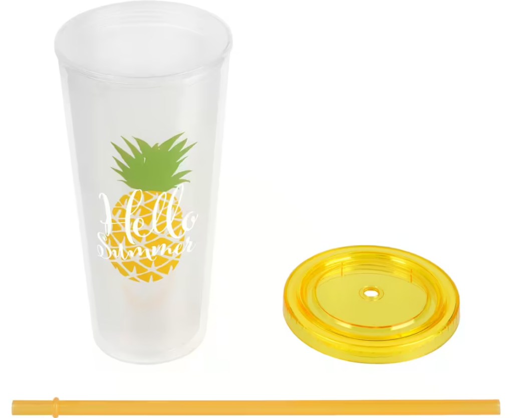 Tumbler with a pineapple on it and the lid next to it with the straw below both
